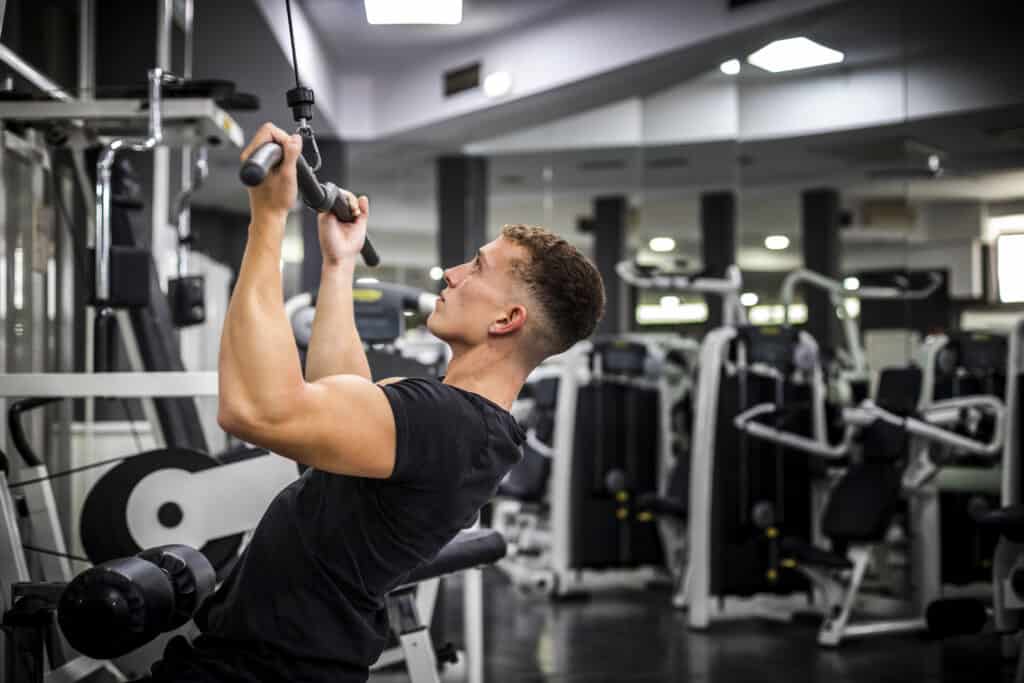 man doing lat pulldown at the gym